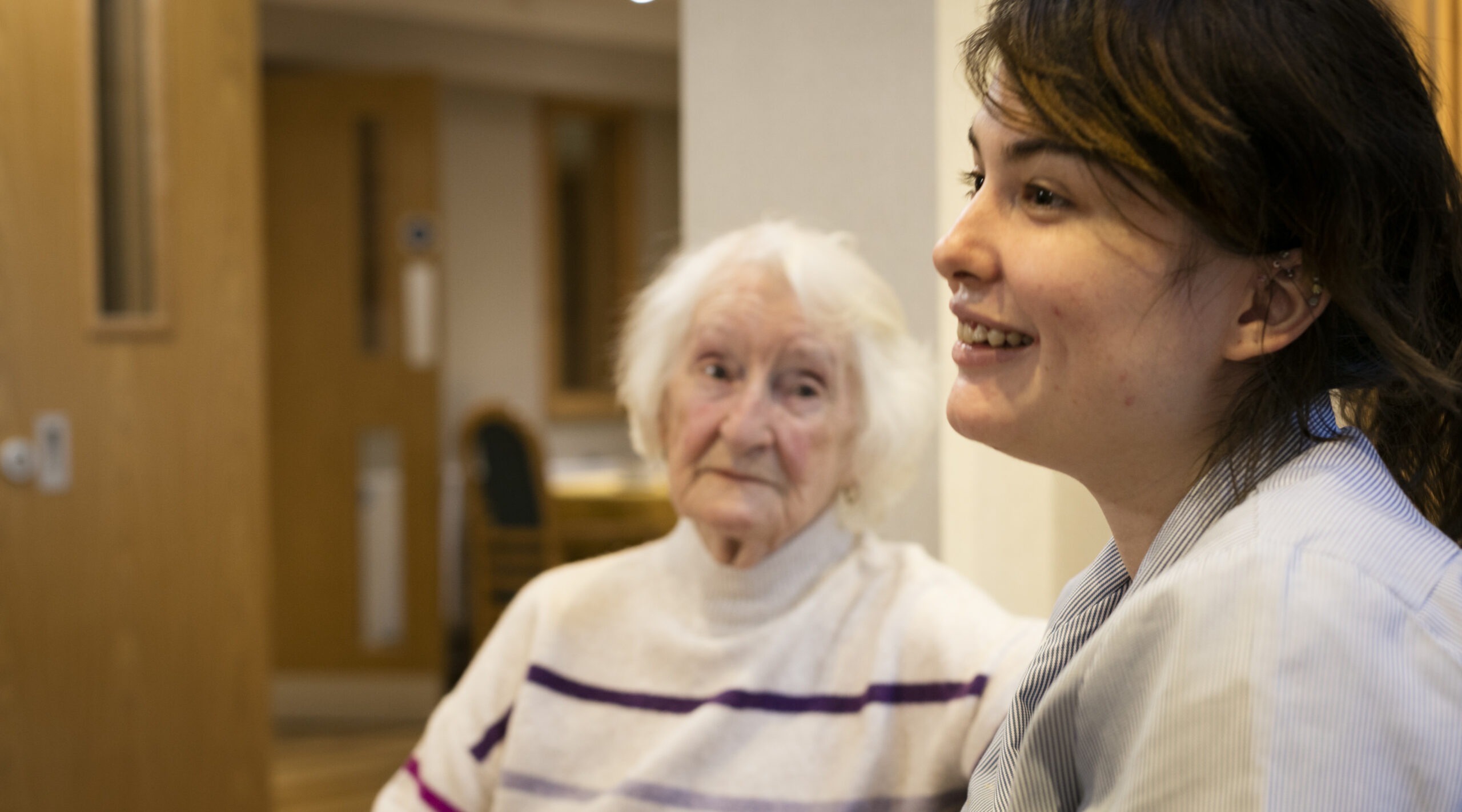 Carer and a residents together in a home